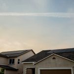Suburban home with garage and solar panels on roof
